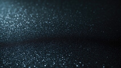 Obraz premium Black sandpaper texture background exhibiting a gritty and rough surface.