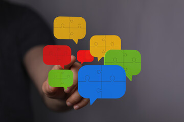 Colorful puzzle pieces in speech bubbles represent teamwork, communication, and problem-solving.
