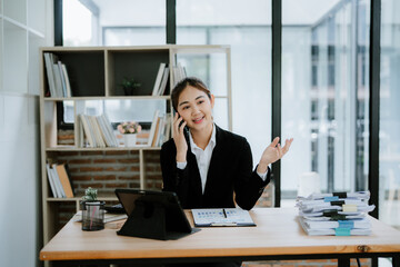 Effective multitasking at work. Serious and busy female entrepreneur. Executive talking on the...