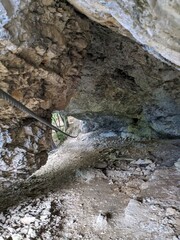 Climber ascending Koschlak Klettersteig via ferrata route in Austrian Alps on secured rock faces.