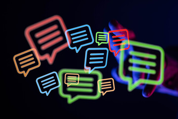 Abstract image of colorful neon speech bubbles, representing communication, online chat, or social media.