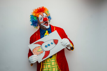 Clown holding drawing of a rocket