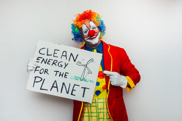 Clown holding sign about clean energy