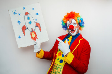 Clown holding cardboard with drawing