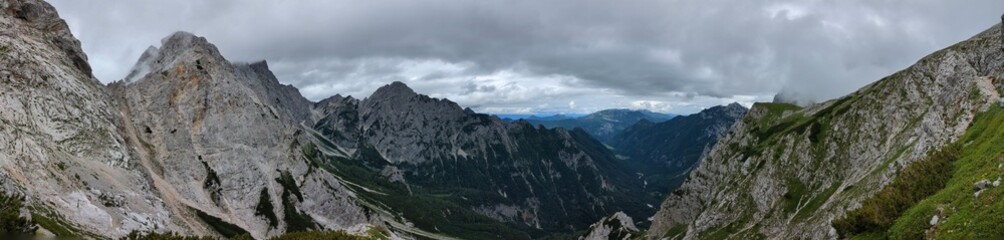 Panoramic view of Logarska dolina valley with peaks of Slovenian Alps covered by passing clouds. © Semi