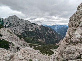 Panoramic view of Logarska dolina valley with peaks of Slovenian Alps covered by passing clouds.