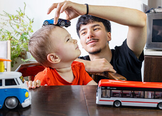  Two Jewish Half-brothers - 2,5 and 17 year old are playing with model cars.
