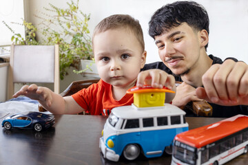  Two Jewish Half-brothers - 2,5 and 17 year old are playing with model cars.
