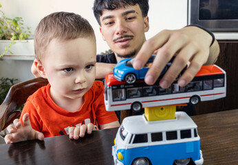  Two Jewish Half-brothers - 2,5 and 17 year old are playing with model cars.