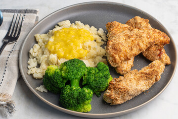 chicken tenders with mashed potatoes top with cream corn