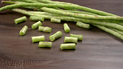 Fresh organic or French beans green peas on wooden background.Healthy food concept.