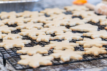 Cooling Snowflake-Shaped Sugar Cookies on a Rack