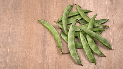 Pile of green beans over wooden background, Healthy food concept 