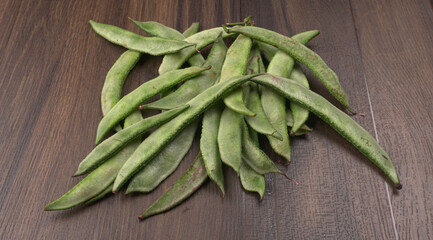 Pile of green beans over wooden background, Healthy food concept 