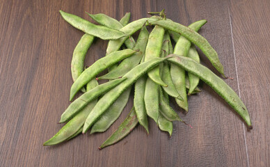 Pile of green beans over wooden background, Healthy food concept 