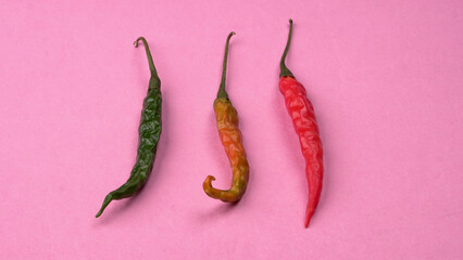 Fresh long Indian green and red chillies on beautiful background. Organic Indian spices for hot and...