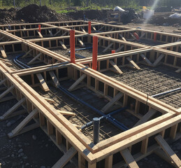 Cottage Foundation: Iron Fittings and Pipes Ready for Concrete Slab