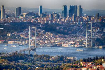 Beautiful view of the Bosphorus Bridge (15 July Martyrs Bridge) in Istanbul, Turkey, with modern skyscrapers, colorful buildings, and the Bosphorus Strait connecting Europe and Asia. 