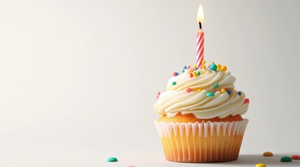 Celebrate special moments with a beautifully decorated birthday cupcake featuring a vibrant candle glowing against a minimalist white backdrop