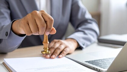 close-up shot of a hand applying a legal stamp to a contract in an office, signifying the final approval and authentication of important business documents.