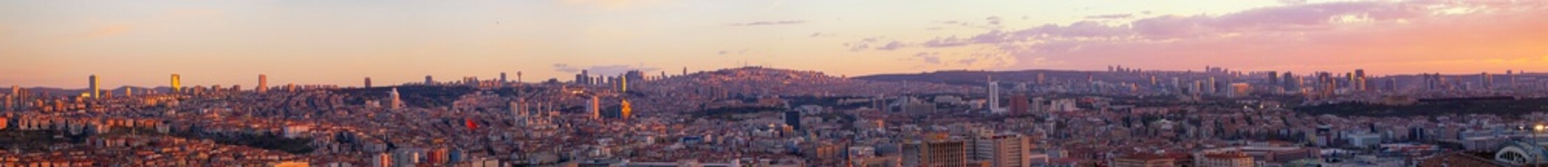 Panoramic view of Ankara at sunset with city skyline, modern buildings, and warm sky tones. Capital city of Turkey showcasing urban life, architecture, and cultural blend under vibrant evening light.