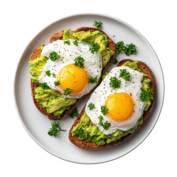 Two avocado toasts topped with fried eggs and parsley on a white plate presented from above