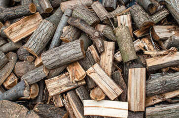 Scattered pile of chopped firewood. Stacking firewood. Chopped firewood for winter. Abstract...