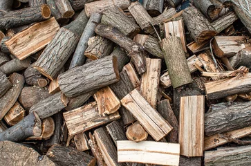 Fototapete Rund Brennholz Scattered pile of chopped firewood. Stacking firewood. Chopped firewood for winter. Abstract background of chopped logs.  © Todayphoto