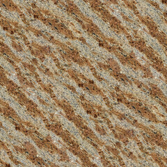 A granite surface with bold diagonal streaks in beige, brown, and gray, coarse texture and rugged depth.