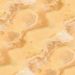 A golden-yellow onyx surface with circular and wavy veining, intricate organic patterns and warm depth.