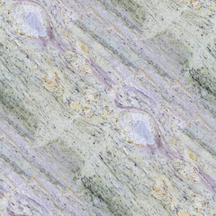 A layered stone surface with green, beige, and purple striations, rough texture and geological depth.