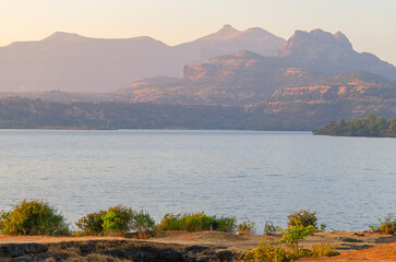 Serene landscape at dusk with a lake at Bhandardara also known as Wilson Dam, Maharashtra, India.