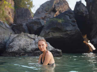 Fototapeta premium Young woman enjoying serene evening at sea in Krabi, Thailand