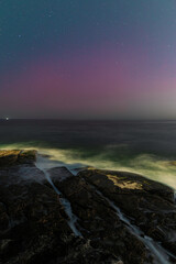 Pink aurora australis over the beach, Sydney, Australia.