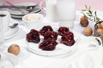 Nuts and dried fruits in pomegranate juice on a plate. Churchkhela. Georgian churchkhela in pomegranate juice