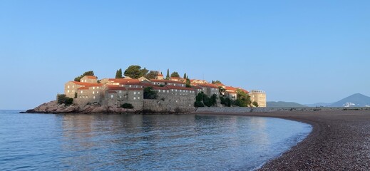 Montenegro Adriatic Sea coast Sveti Stefan, sandy beach and next to luxury resort island, panorama