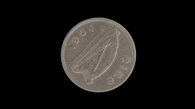 Ireland 1964 sixpence coin obverse with Irish harp and date rotating on black background