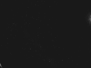 Abstract dirty dust particle grain texture for overlay effect with space for vintage grunge design. White dust on a black background. Noise black background overlay, abstract film noise, black texture