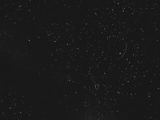 Abstract dirty dust particle grain texture for overlay effect with space for vintage grunge design. White dust on a black background. Noise black background overlay, abstract film noise, black texture