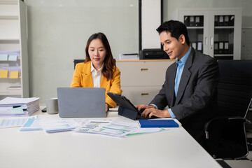 financial asian advisor showing plan of investment to clients in the consultancy office.