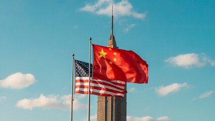 Flags of America and China Against Skyline Featuring Iconic Skyscraper