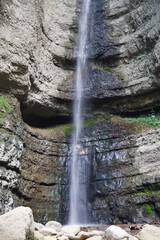 View of a falling waterfall in the Caucasus Mountains