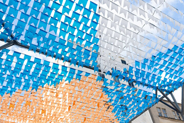 Decoration of the June festival with colorful flags. Plastic objects attached to the top.