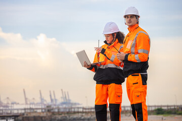 Dock Worker in Safety Uniforms Working at Harbor Site, Industrial Engineers Collaborating at Port...