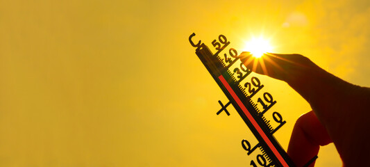 Hot weather - Heat wave / Summer heat background - Thermometer yellow orange sky and sun rays