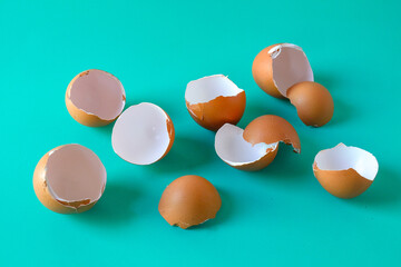 brown egg shell broken or crack on color background.