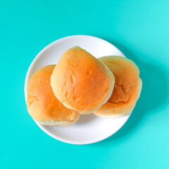 Fresh buns in baking dish on table.