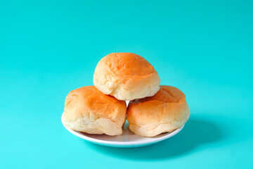 Fresh buns in baking dish on table.