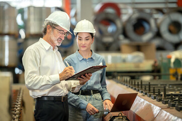 woman engineer assistant secretary in helmet inspection check control heavy machine construction installation in industrial factory with boss manager. Boss and partnership check maintenance factory