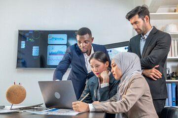 officer collaboration teamwork multiethnic coworkers look laptop and wait hope for win in Online auction biding in office company. multiracial office worker employee look monitor wait good news.